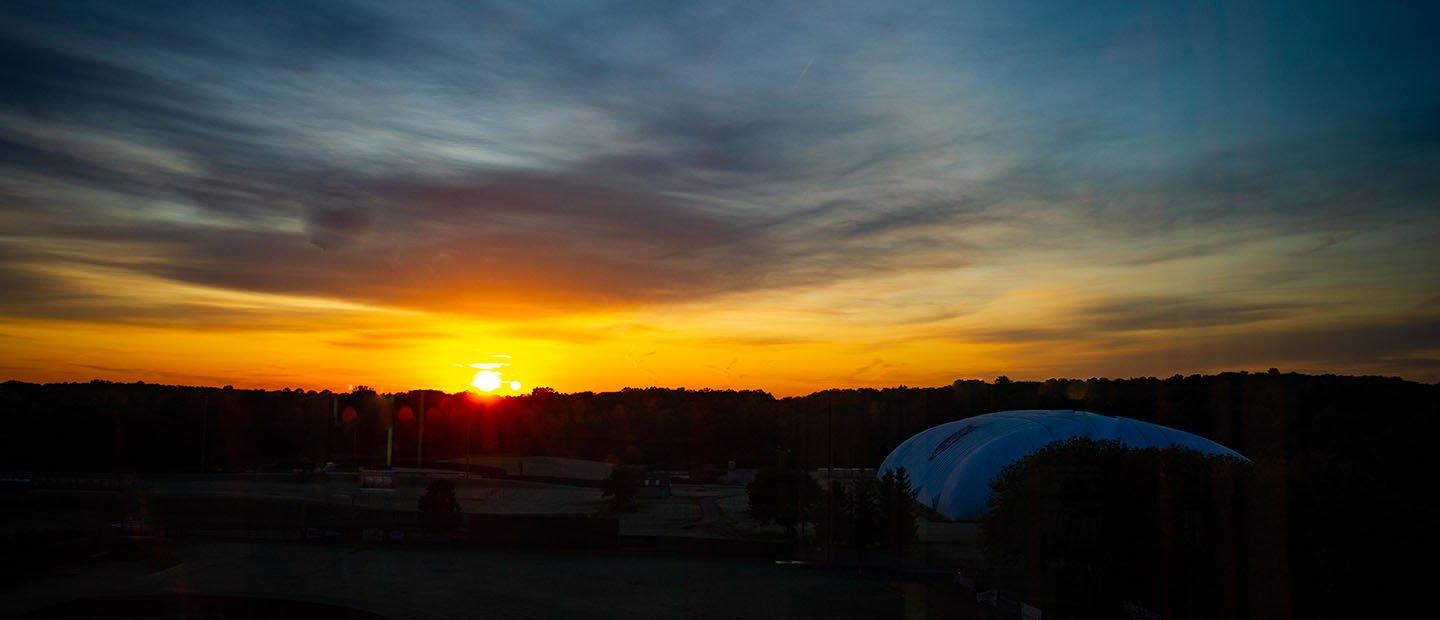 sun setting over Oakland University campus