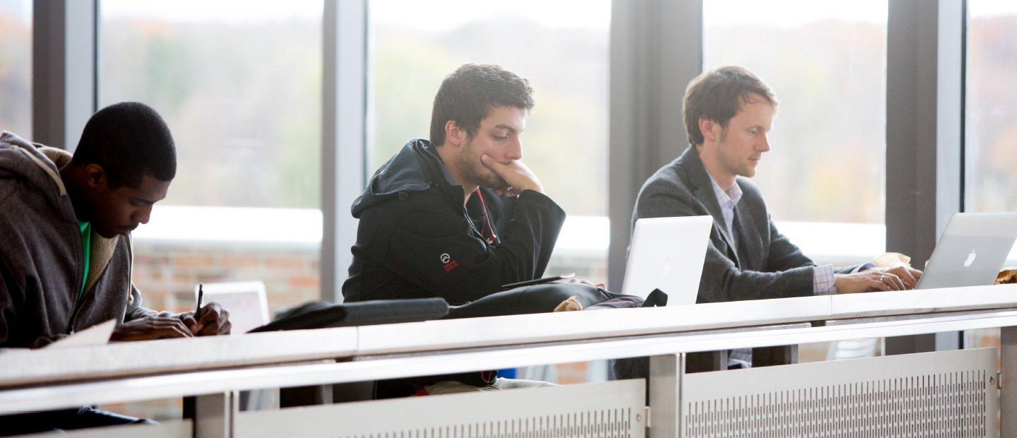 3 students looing at computers