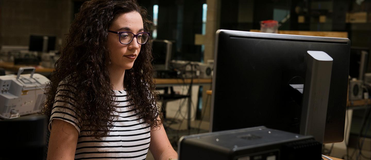 Girl with Glasses working on a computer